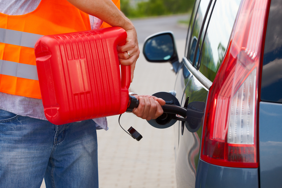Man pouring fuel Man pouring fuel into the gas tank of his car from a red gas canister.